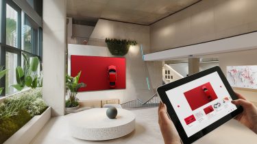 Showroom: Two hands holding a tablet, on the screen you can see a web application from B12-Touch